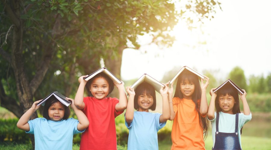 Close up of girl child friends in a park smiling to camera